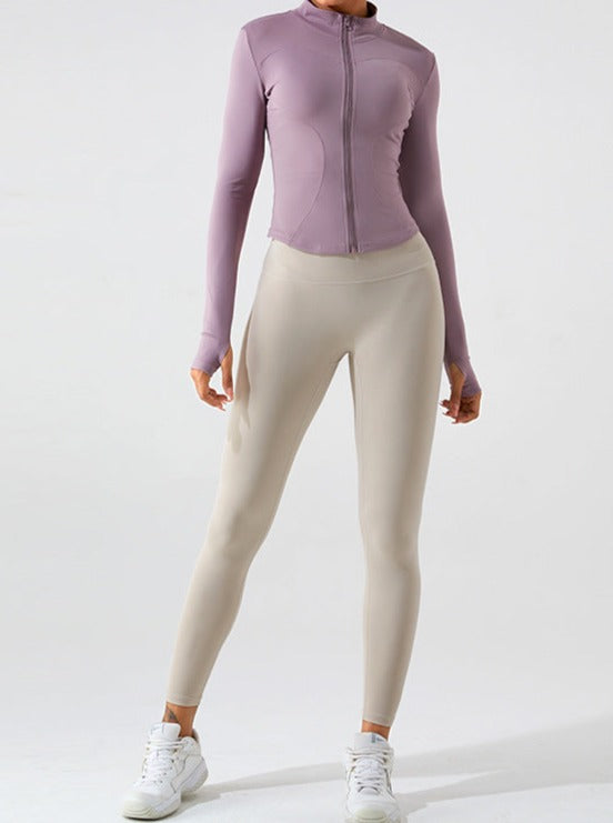 Damen-Sportbekleidung: Lila Langarm-Trainingsjacke und beige Leggings. Ideal für Fitness, Yoga und Freizeit. Bequem und stilvoll.