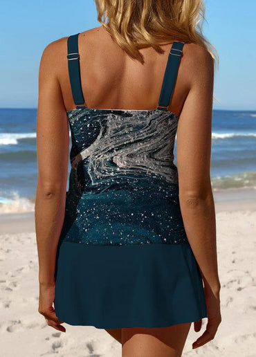 Frau am Strand in einem eleganten, blau-gemusterten Badeanzug. Sommermode, Strandkleidung, Damenbademode, stilvoller Badeanzug, Meer.